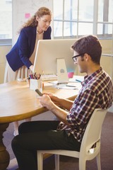 Obraz premium Two colleagues working in the same office