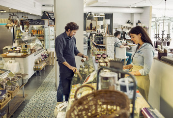 People working in delicatessen 