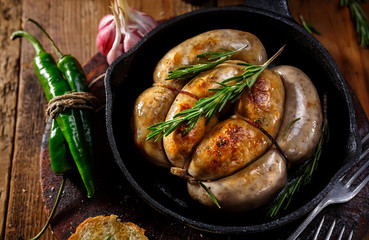Fried sausages in a frying pan