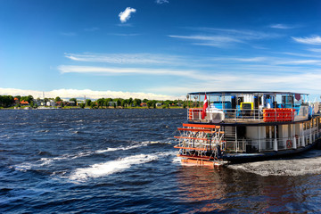 Vintage ship wheel on the river on a sunny day