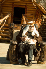 Fototapeta na wymiar Old druid sits in chair