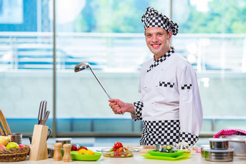 Male cook preparing food in the kitchen