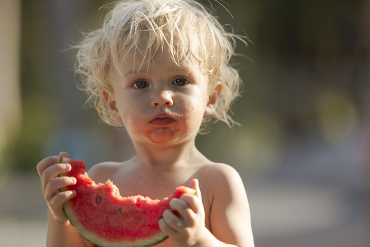 Little boy eating watermelon