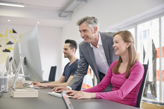 Mature businessman helping coworker