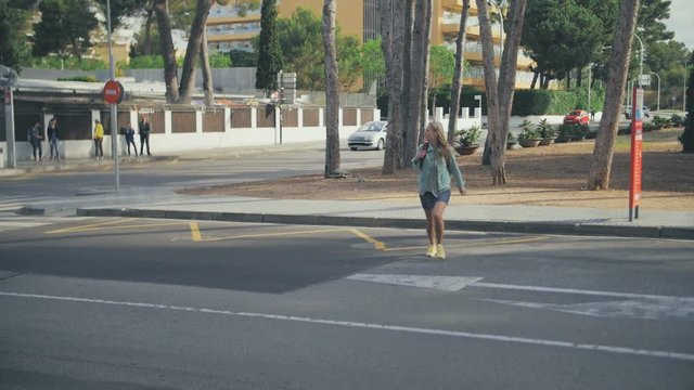 Young girl looking around and crossing the road in the wrong place. Break and violate the rules