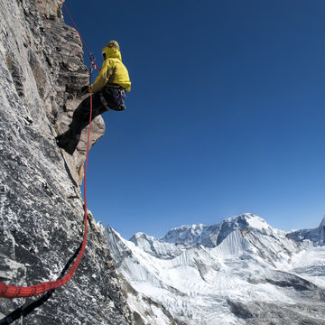 Nepal, Himalaya, Solo Khumbu, Everest region Ama Dablam, mountaineer with rope at rock face