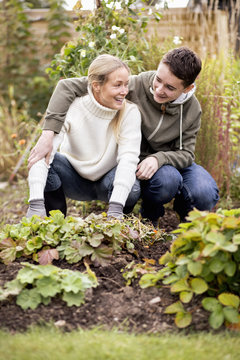 Mother and son gardening at yard