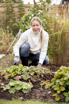 Smiling mature woman gardening at yard