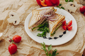 Fototapeta na wymiar Sandwiches on parchment background with vegetable composition