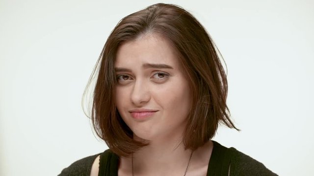 Sceptic sarcastic girl doesn't trust you. Close up. Slow motion