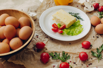 Omelet with ham on parchment background. Vegetable composition