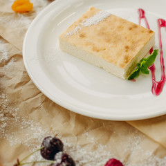Casserole on parchment background, square, close up