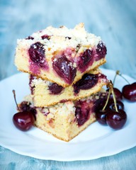 Slices of home made butter cherry cake with crumble topping