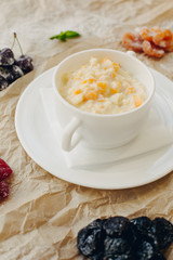 Millet porridge with pumpkin. Brown parchment background.
