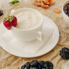 Rice porrige with strawberry on parchment background