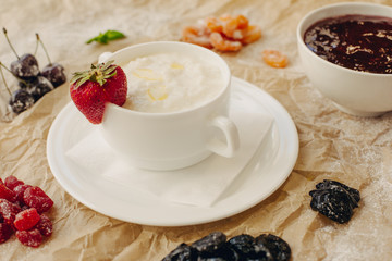 Rice porrige with strawberry on parchment background