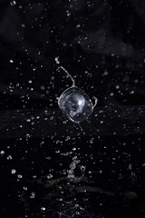Ice cube flying with splashes on a black background #5