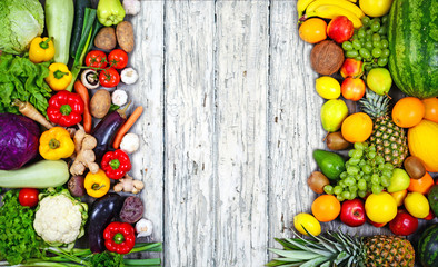 Huge group of fresh vegetables and fruit on wooden background -