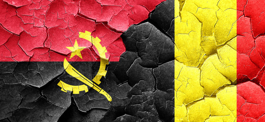 Angola flag with Belgium flag on a grunge cracked wall