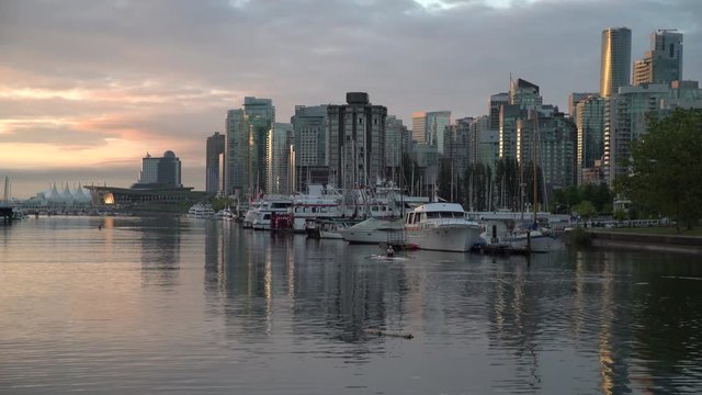 Coal Harbor Skyline, Vancouver. 4K UHD. Vancouver's city center and Coal Harbor at sunrise. Rowing team practice. British Columbia, Canada. 4K. UHD.
  