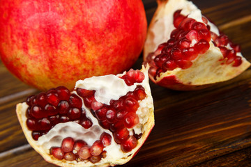 Red juicy pomegranate, whole , half, ripe and broken fruits
