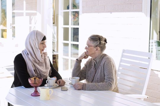 Two women talking at table