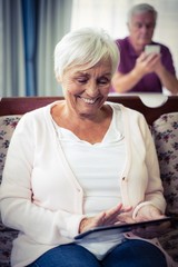 Fototapeta na wymiar Senior woman using digital tablet