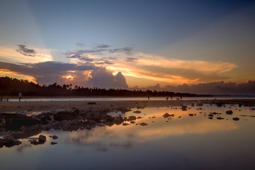 Fototapeta na wymiar Sunset scene with mirror reflection on a tropical sea beach. in Bali.