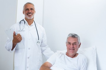 Portrait of happy male doctor and senior man