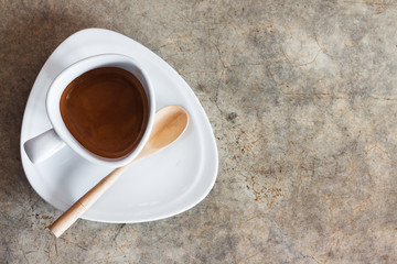 Obraz na płótnie Canvas White Coffee cup on concrete table with copy space.