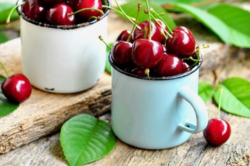 Fresh organic cherries on the old wooden background.