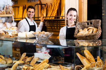 Bakery staff offering bread and different pastry