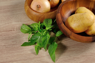 onions ans potatos close up on wood