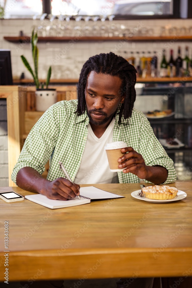 Poster Man writing in a notebook