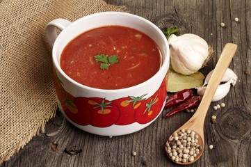 Domestic tomato soup in bowl with paper for recipe