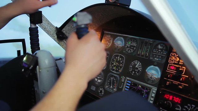 Pilot's hand knocking on breakdown cockpit panel, flight control system error