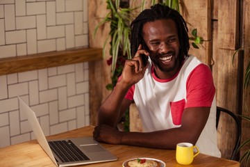 Cheerful hipster man on phone