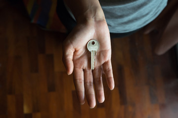 Metal key in female palm