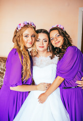Fototapeta na wymiar Beautiful bride and her beautiful bridesmaids, Bridesmaids in purple (violet) dress