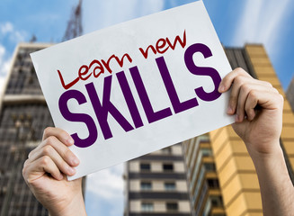 Learn New Skills placard with cityscape background