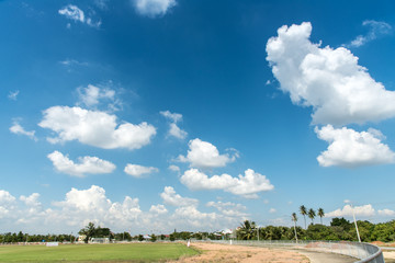 Football field and blue cloud sky.