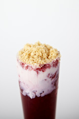 Cocktail with ice-cream, raspberry and cookie crumbs on the white background