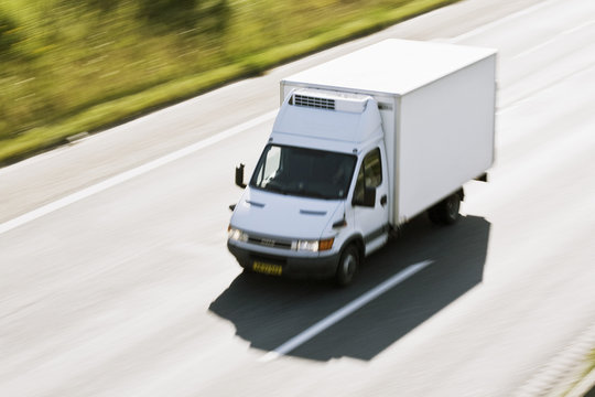 High angle view of delivery van moving rapidly on highway