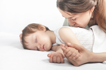 Mother kissing a baby. Care concept