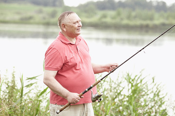 Mature angler on lake