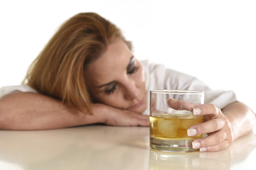 Obraz na płótnie Canvas caucasian blond wasted and depressed alcoholic woman drinking scotch whiskey glass messy drunk