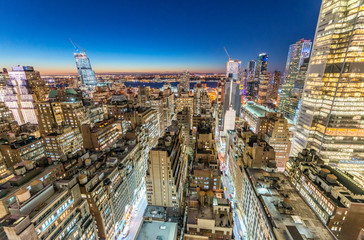 Fototapeta na wymiar Manhattan skyscrapers at night as seen from New York rooftop