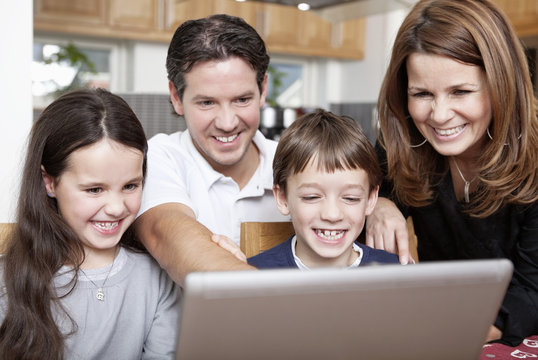 Happy family in front of computer