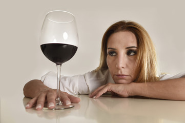 caucasian blond wasted depressed alcoholic woman drinking red wine glass alcohol addiction