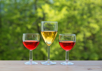  three wine glasses on table in the garden